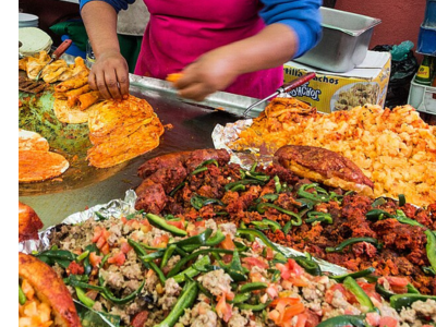 Colorful and abundant food being prepared on a griddle