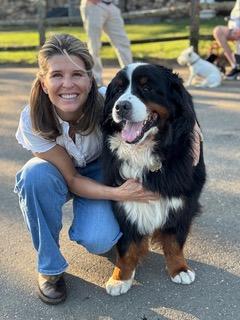 Large black-and-white dog with owner