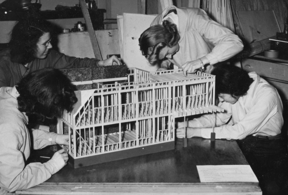 Four women working on an architectural model