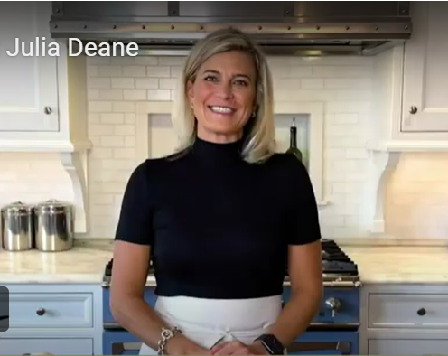 Julia smiling in front of her stove